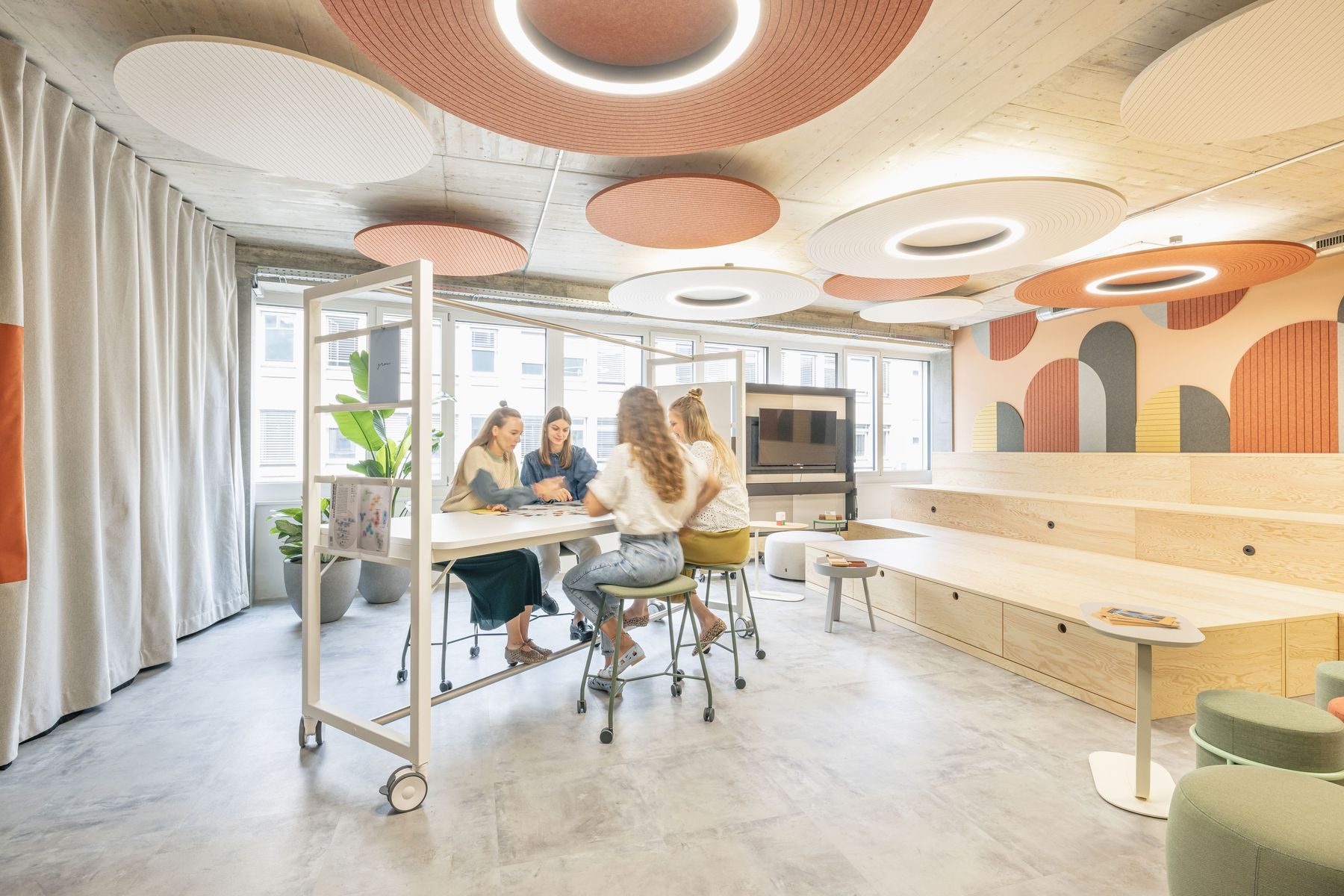 Gruppe im Gespräch an einem Stehtisch im Schulungsraum der Work Factory